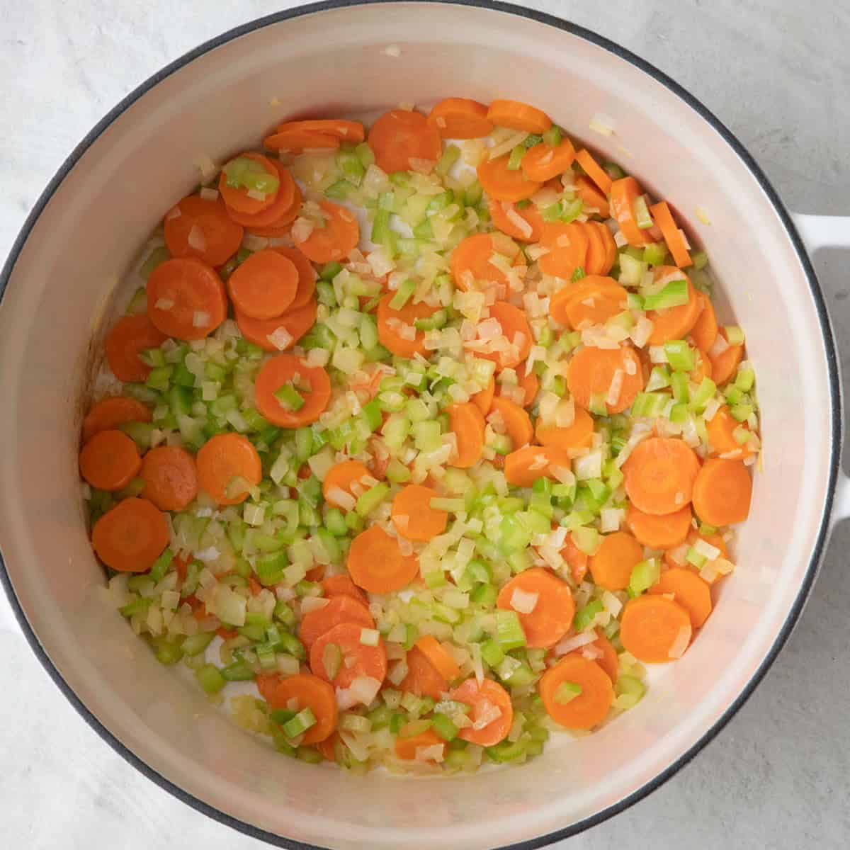 Large Dutch oven with onion, celery and carrots (cooked).