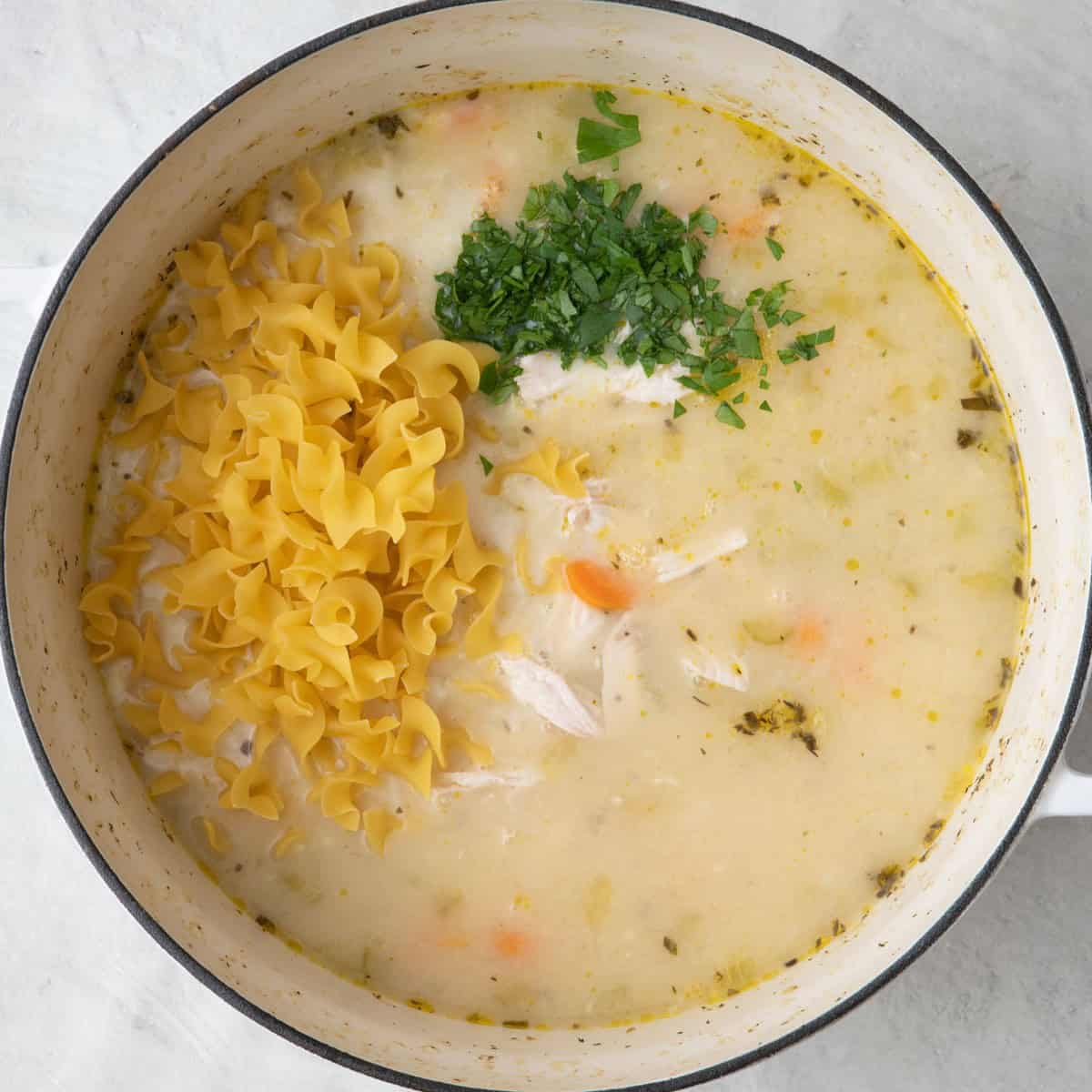 Shredded chicken, egg noodles, milk and fresh parsley added.