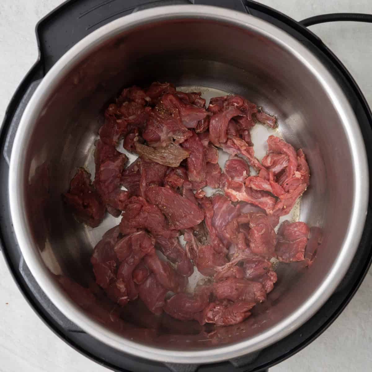 Beef after marinating inside instant pot before cooked.