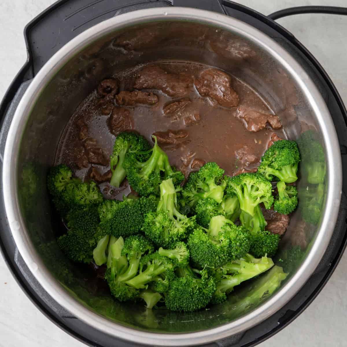 Cooked broccoli added on top of beef (after pressure release).