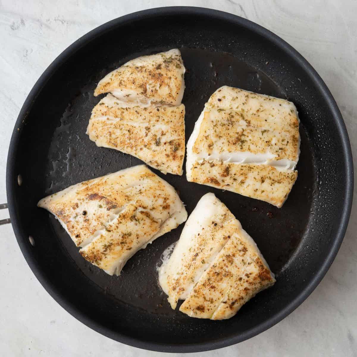 Halibut after flipped on skillet.