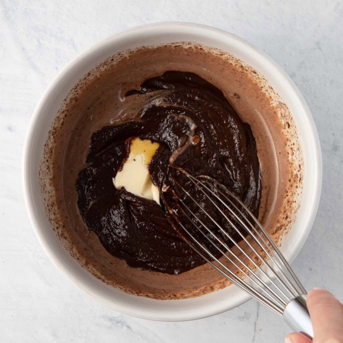 Whisking in butter, salt, and honey added.