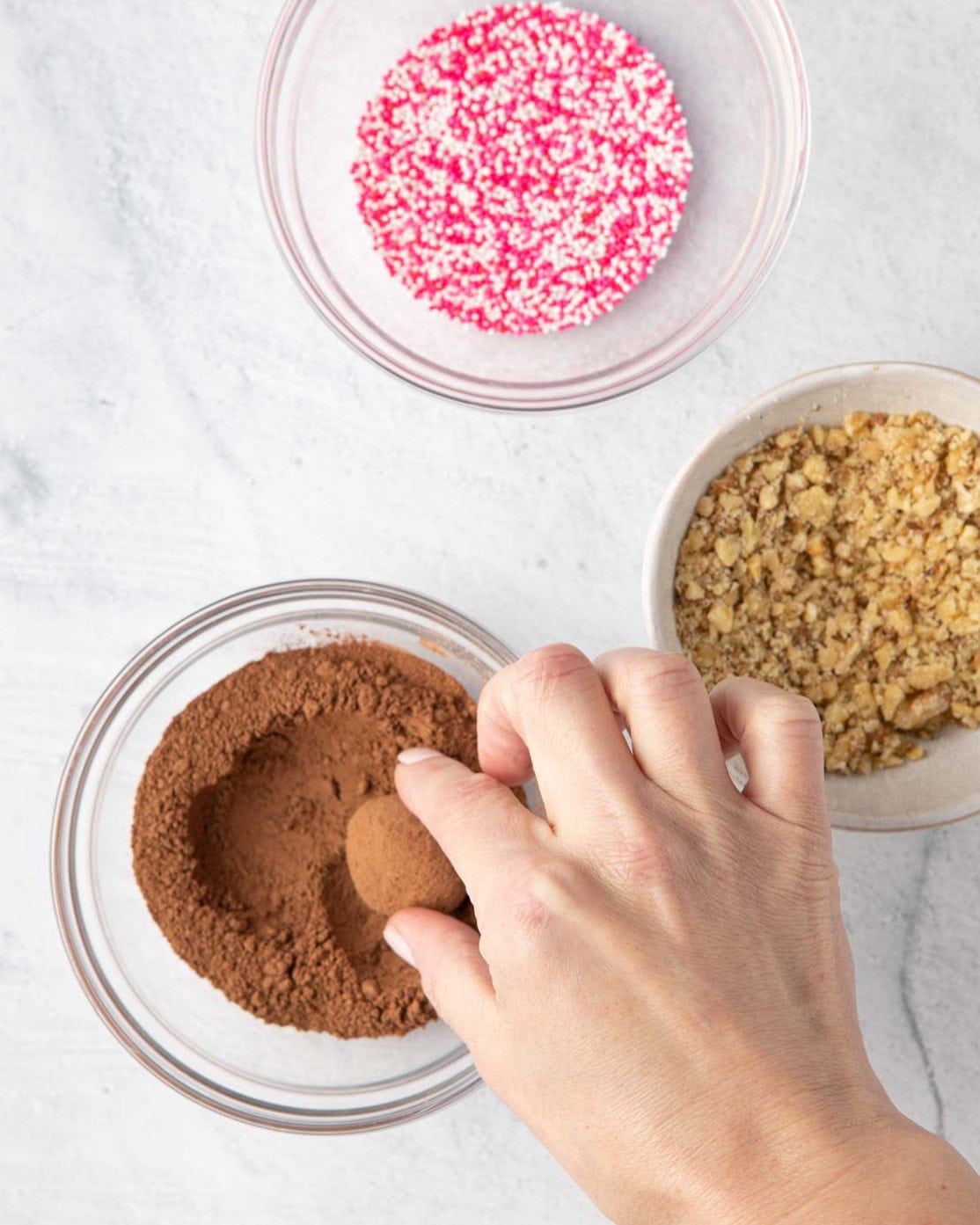 Rolling ganache ball into one of the toppings.