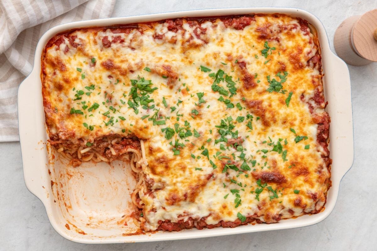 Baking dish of macarona bechamel with a serving removed.