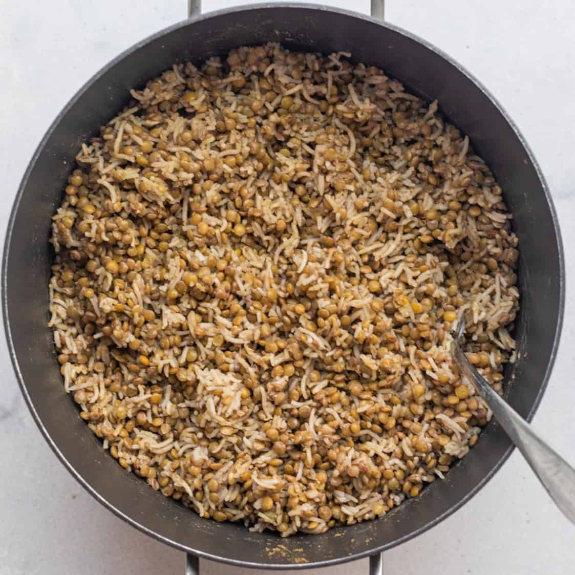 The lentils and rice mixture in the pot after fully cooked and stirred together.