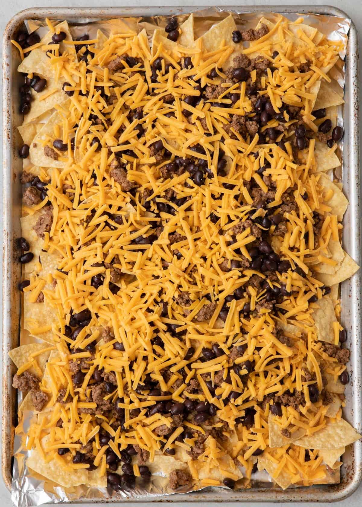 Beef and black beans and cheese added on top before baking.