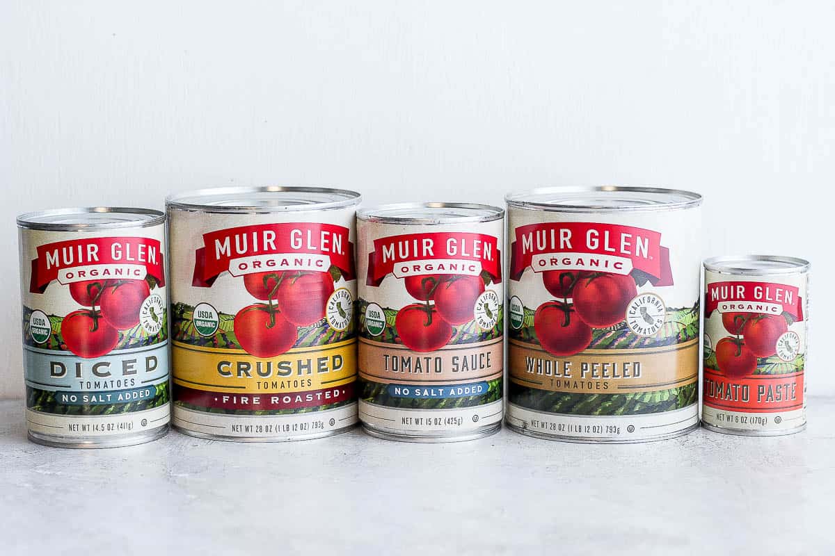 5 different types of canned tomatoes: diced, crushed, sauce, whole peeled, and paste.