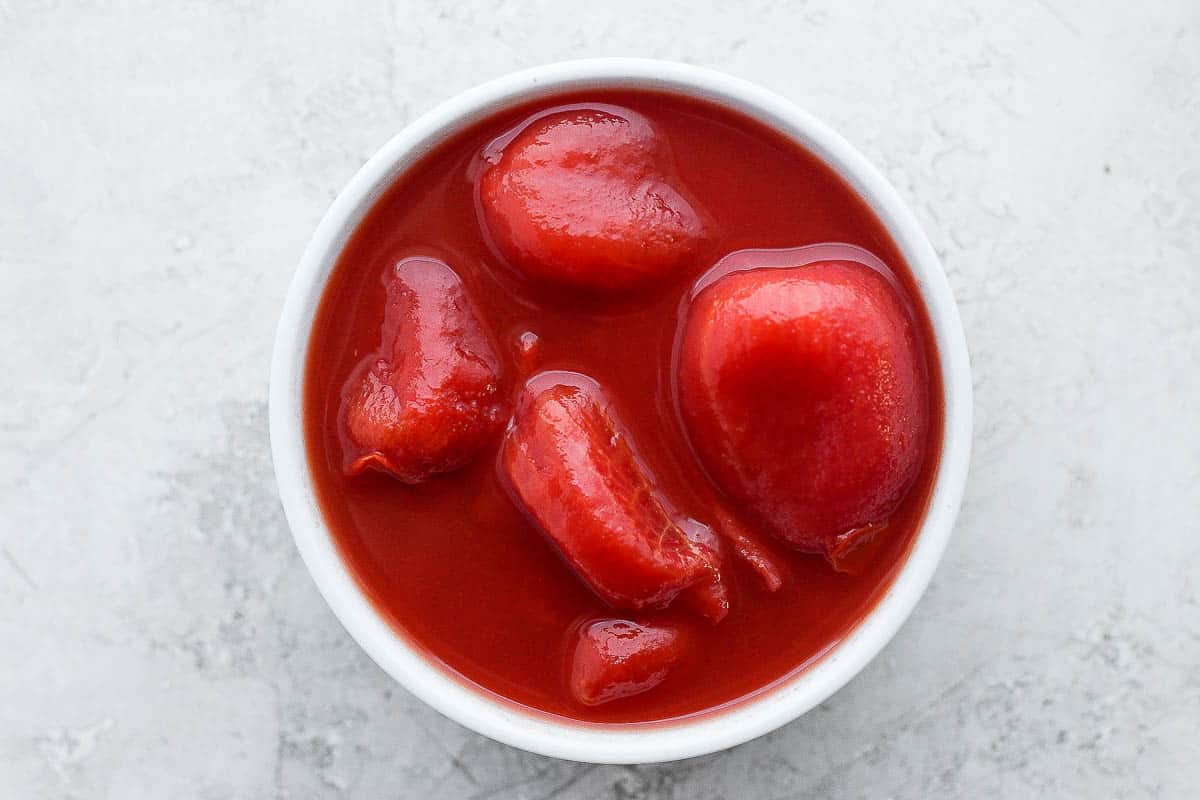 Canned whole tomatoes in a bowl.