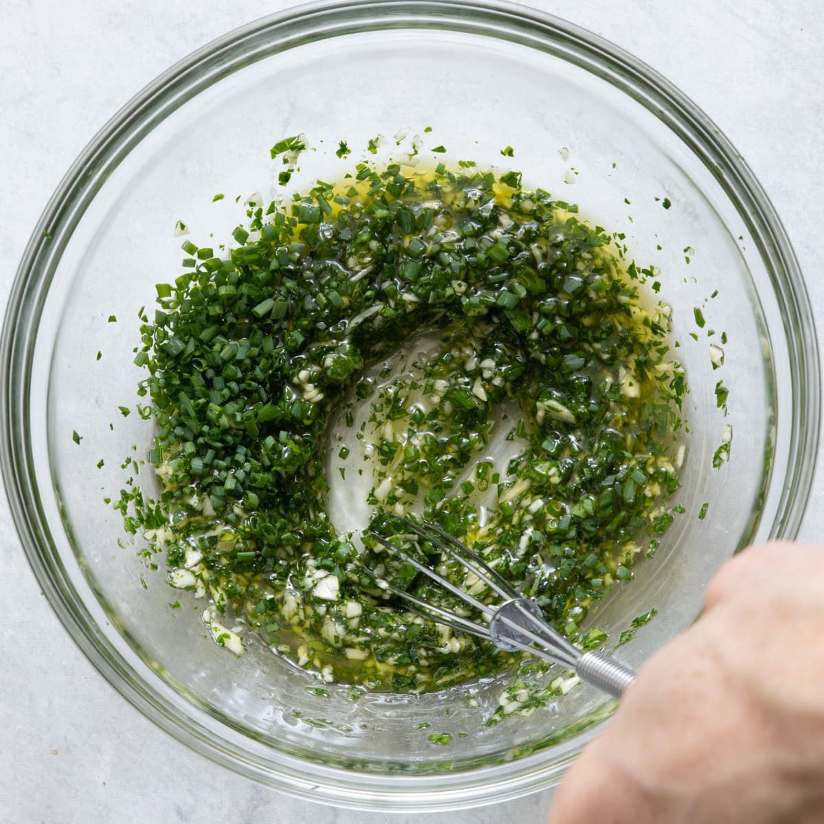 Freshly minced garlic, olive oil, parsley, chives, and salt mixed together.