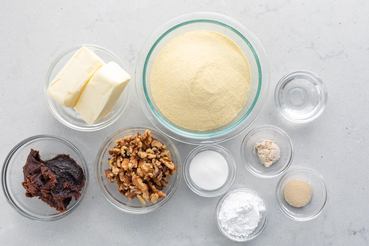 Ingredients for recipe: butter, extra-fine semolina, mahlab, salt, water, sugar, dry active yeast, orange blossom water, date paste, walnuts, powdered sugar.