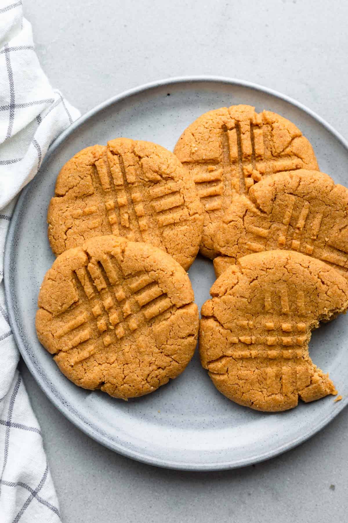 Close up shot of peanut butter cookies, with bite taken out of one