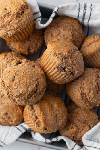 Bran muffins in a cloth lined pan.