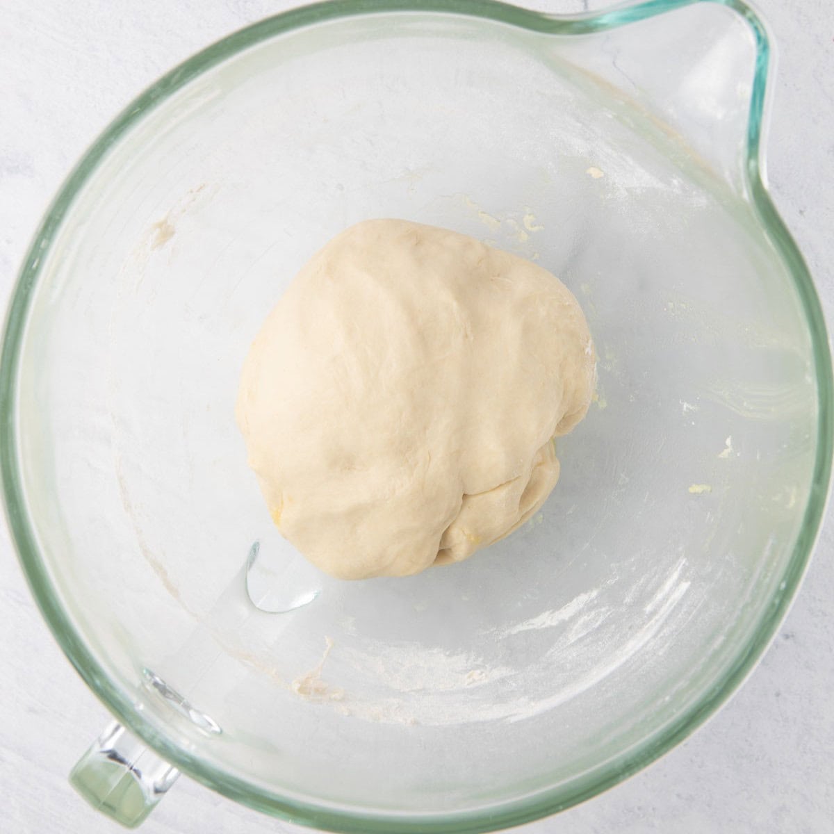 After dough has formed into a smooth, springy ball.