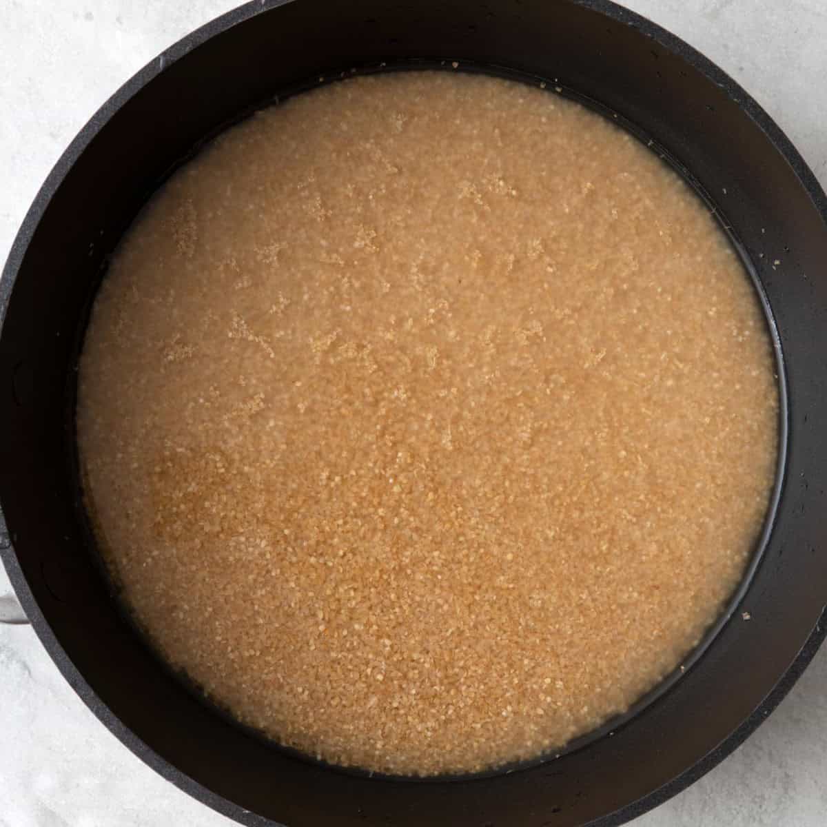Bulgur in a pot with water.