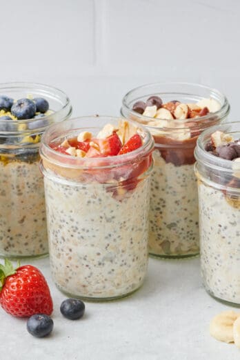 Peanut Butter & Jelly Overnight Oats with other glasses of overnight oats in the background