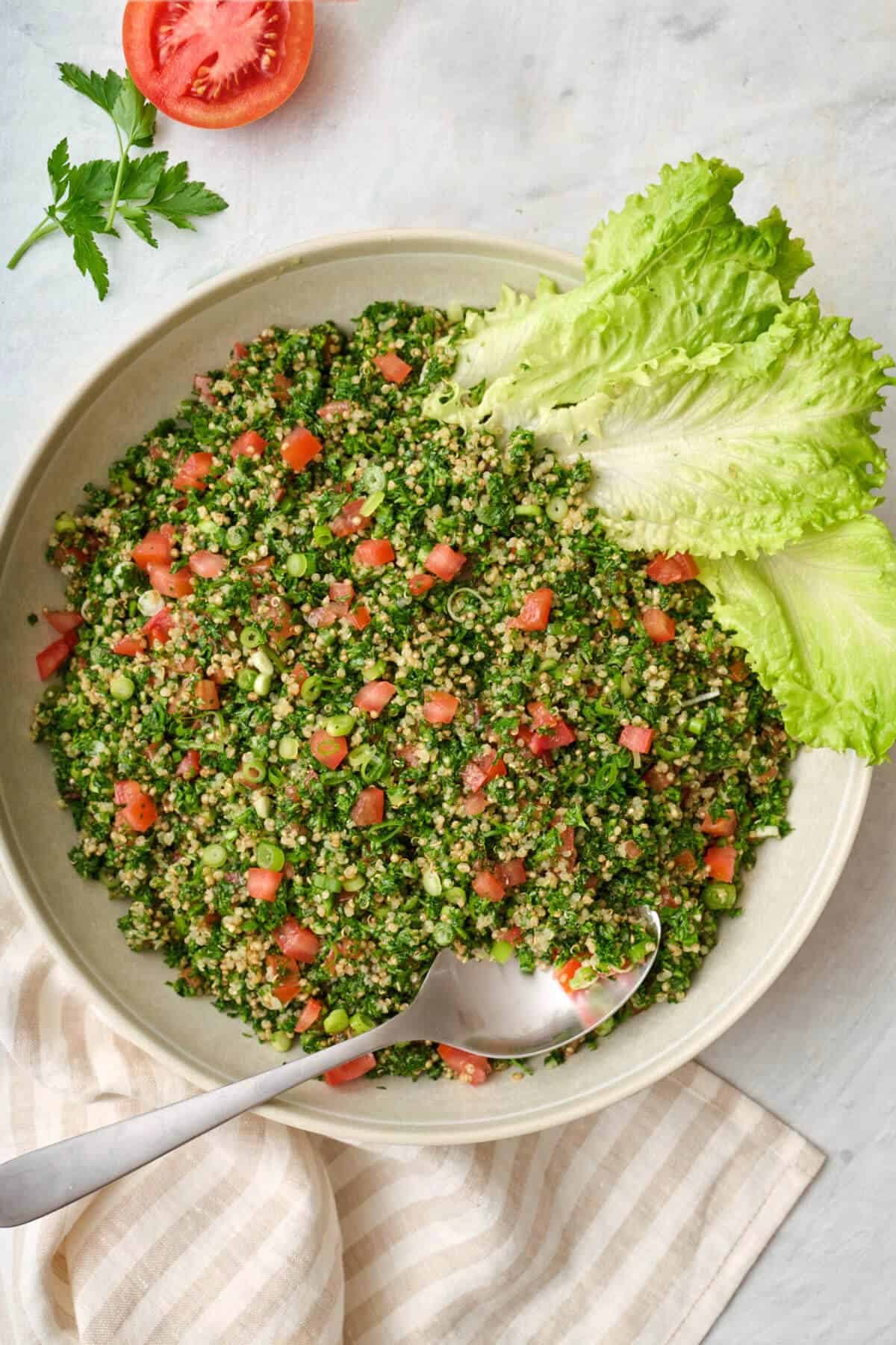 spoon stirring tabbouleh in a bowl
