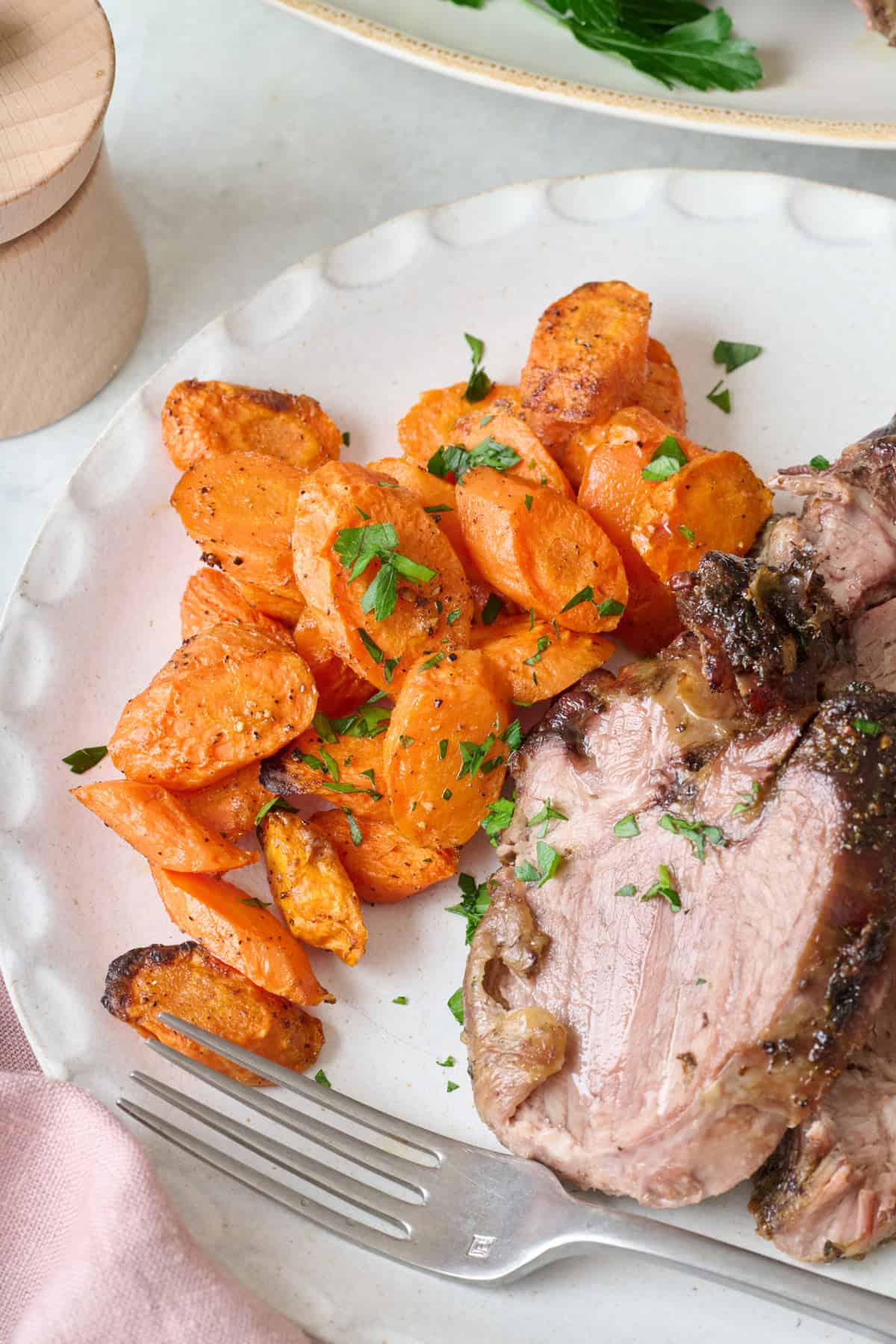 Close up shot of spoon serving oven roasted carrots