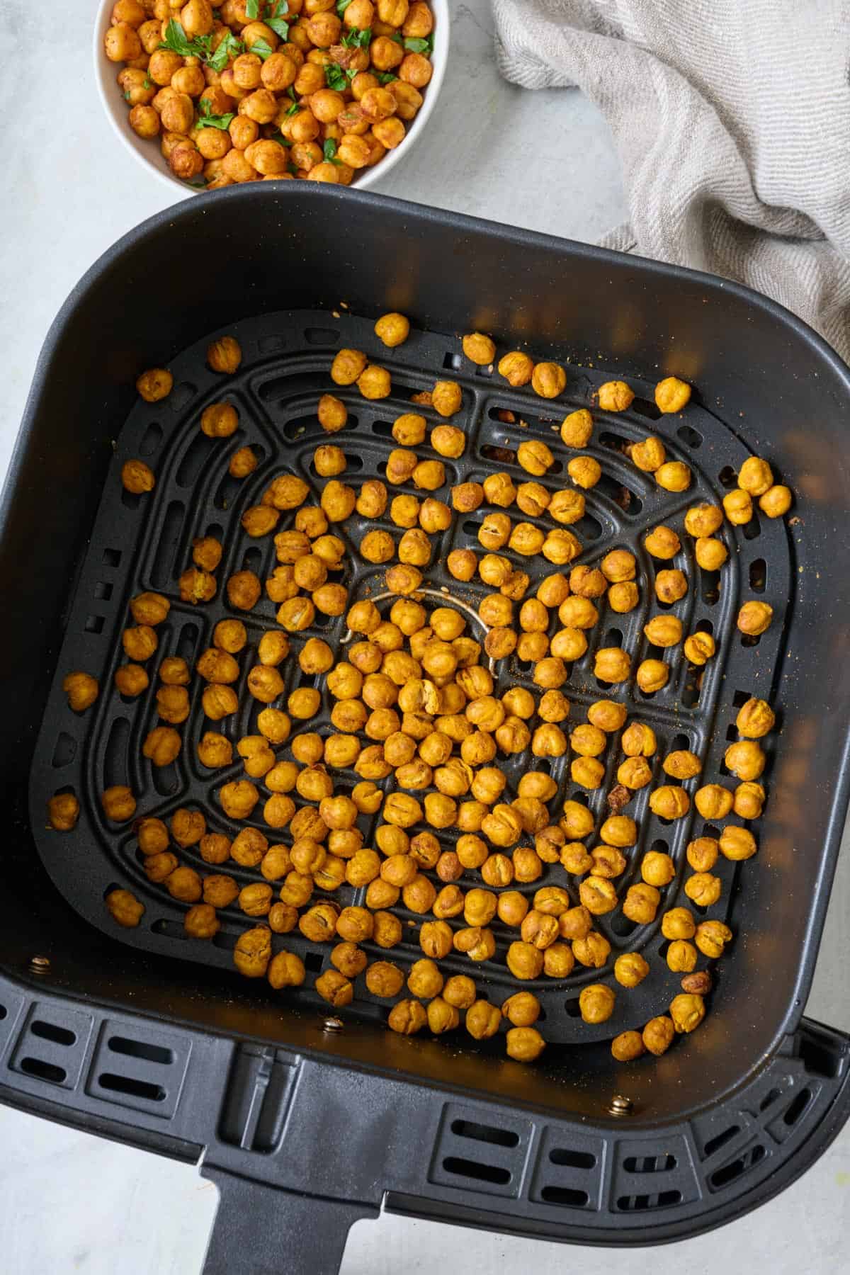 Air fryer roasted chickpeas in an air fryer basket.