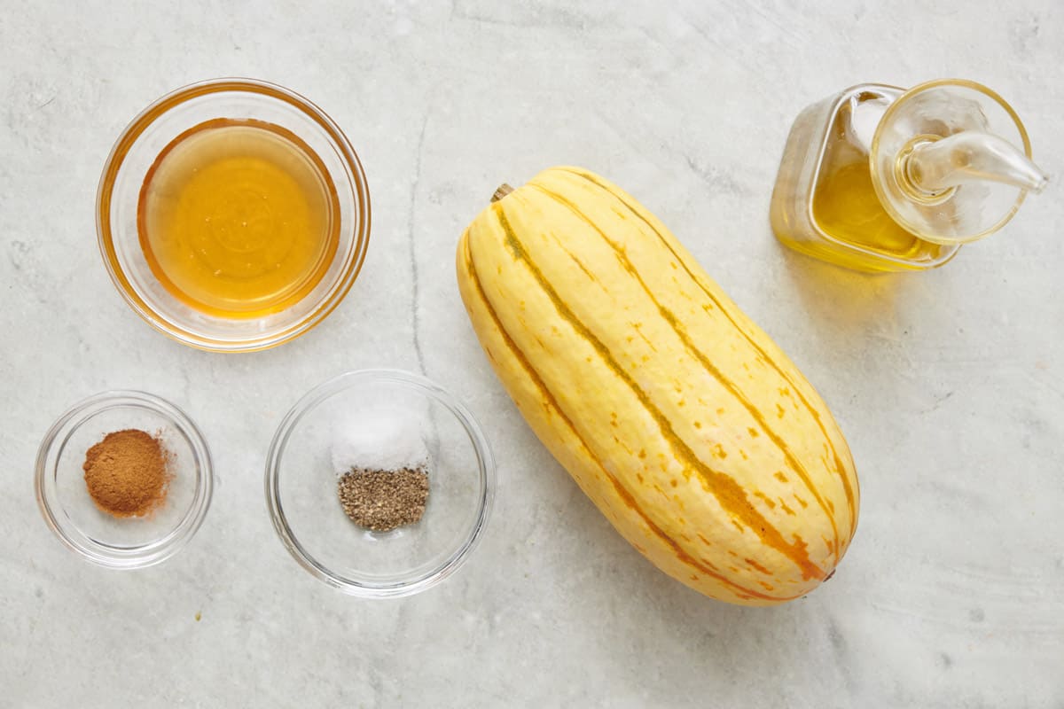Ingredients for recipe: honey, cinnamon, salt, pepper, delicata squash, and oil.