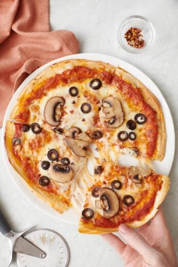 Margarita tortilla pizza sliced into four slices
