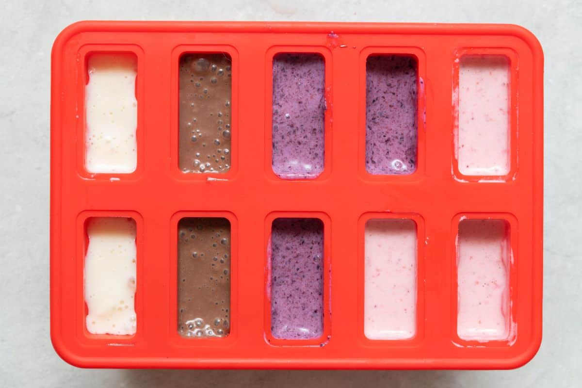 Silicone popsicle mold filled with for different flavors.
