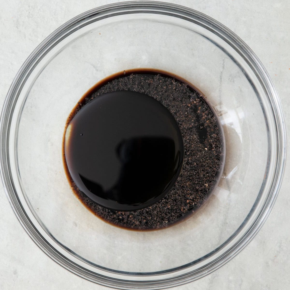 Olive oil, balsamic vinegar, salt and pepper in a bowl before whisking.