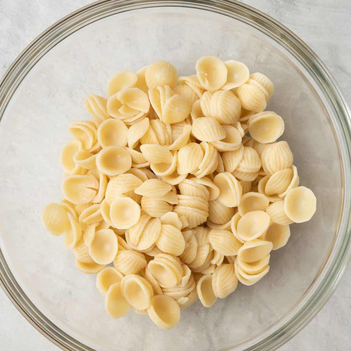 Cooked and cooled pasta in a large bowl.