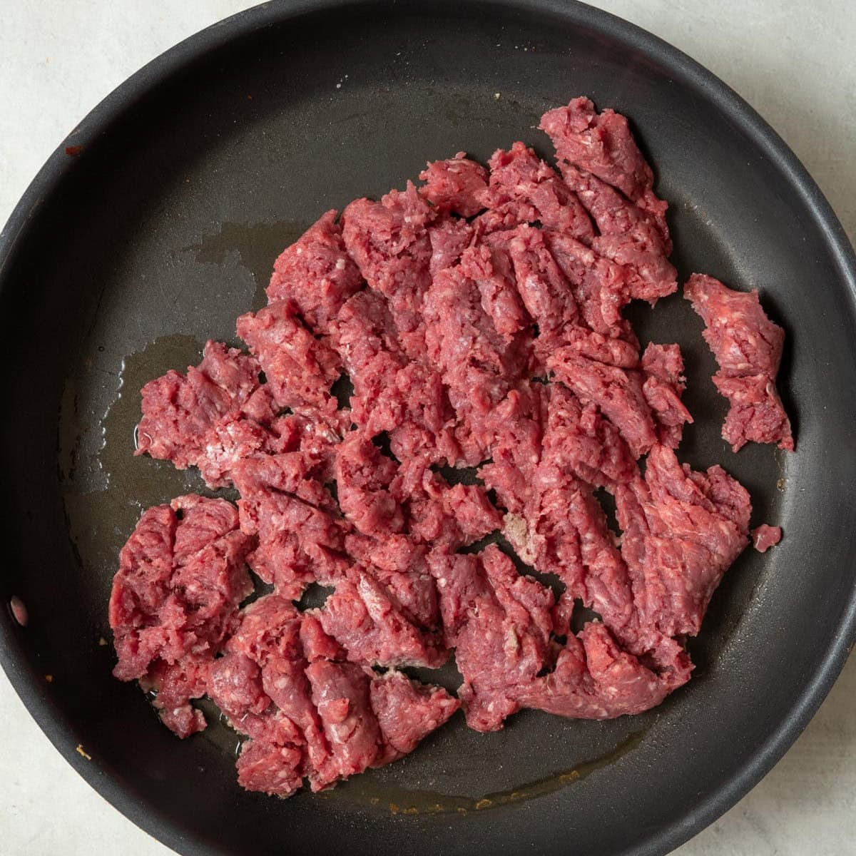 Ground beef and oil in the same pan.