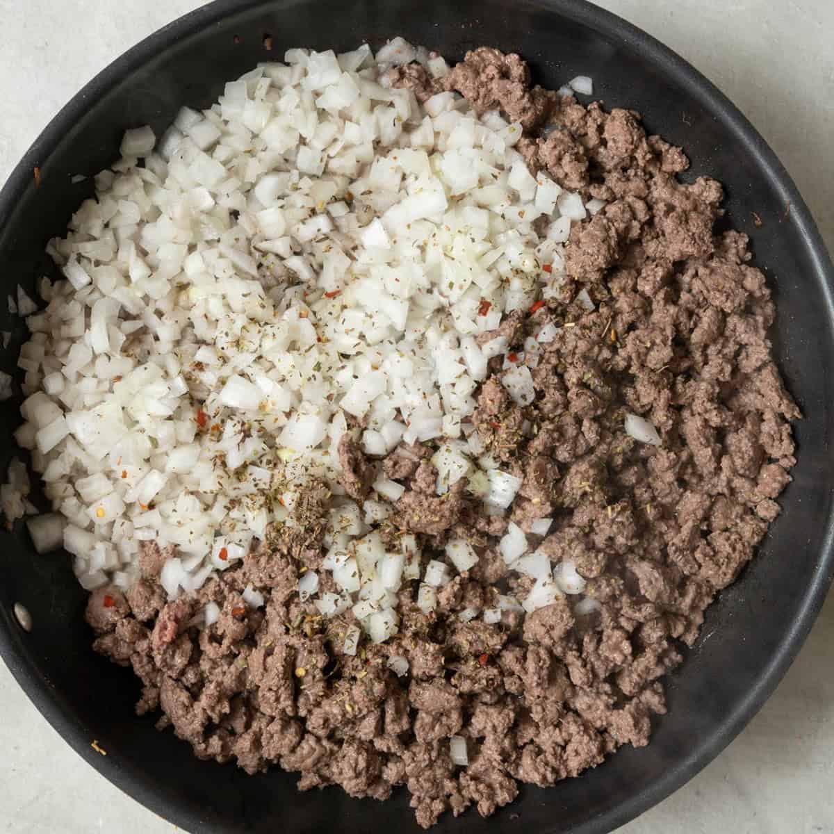 Beef after crumbled and browned with onion and Italian seasoning added.