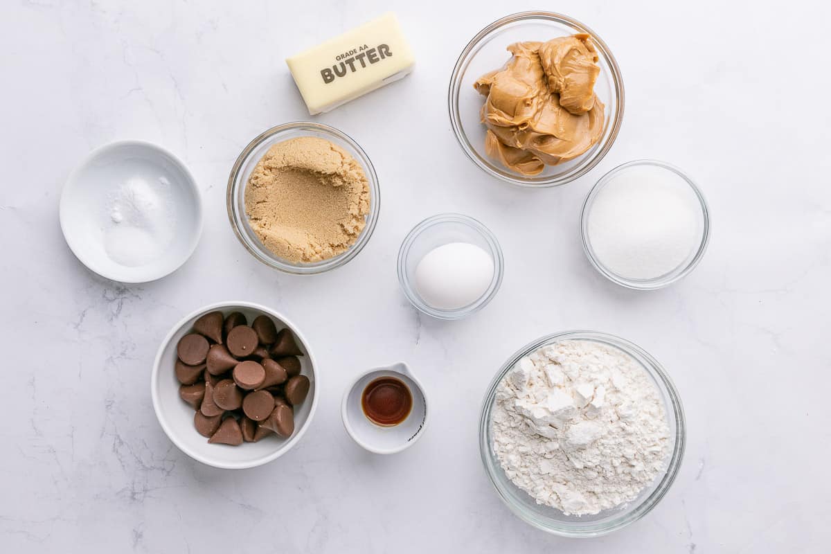 Ingredients for recipe: peanut butter, butter, brown sugar, salt and baking soda, unwrapped Hershey kisses, an egg, vanilla, flour, and sugar.