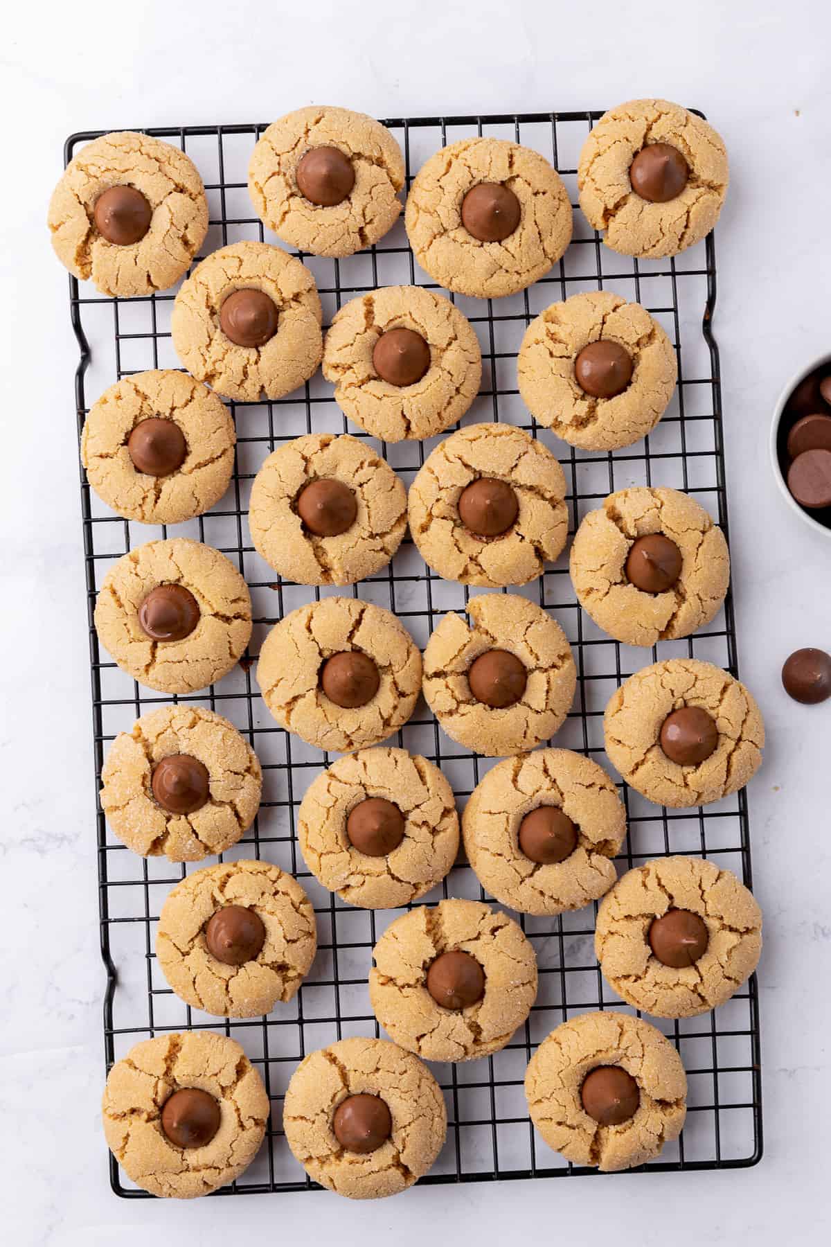Peanut butter blossoms on a wire rack.