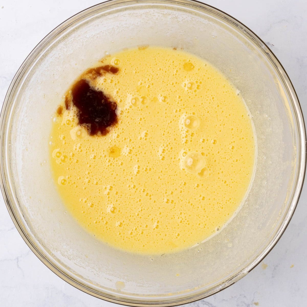 After whisking until pale yellow with almond and vanilla added.