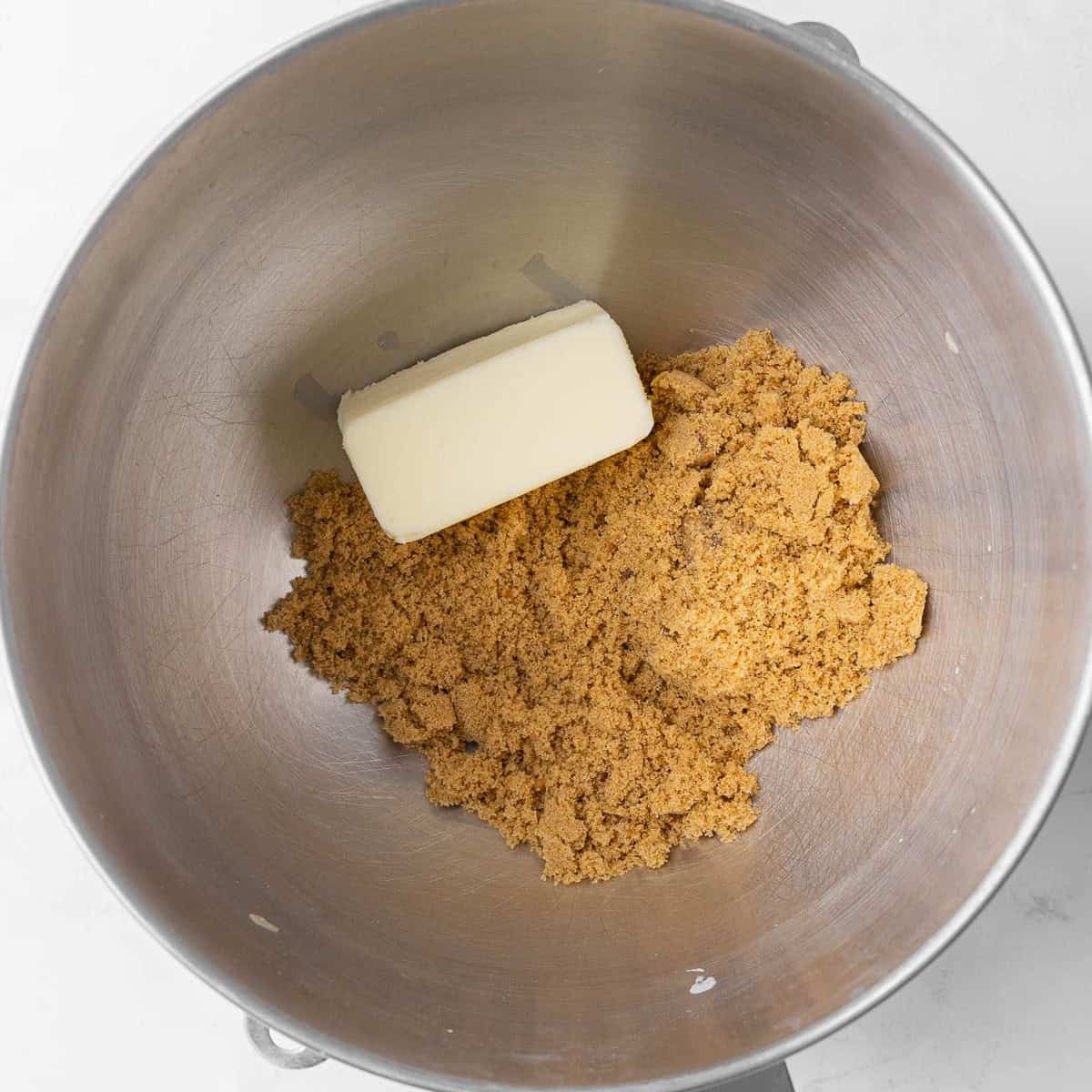 Brown sugar and butter in a mixing bowl.