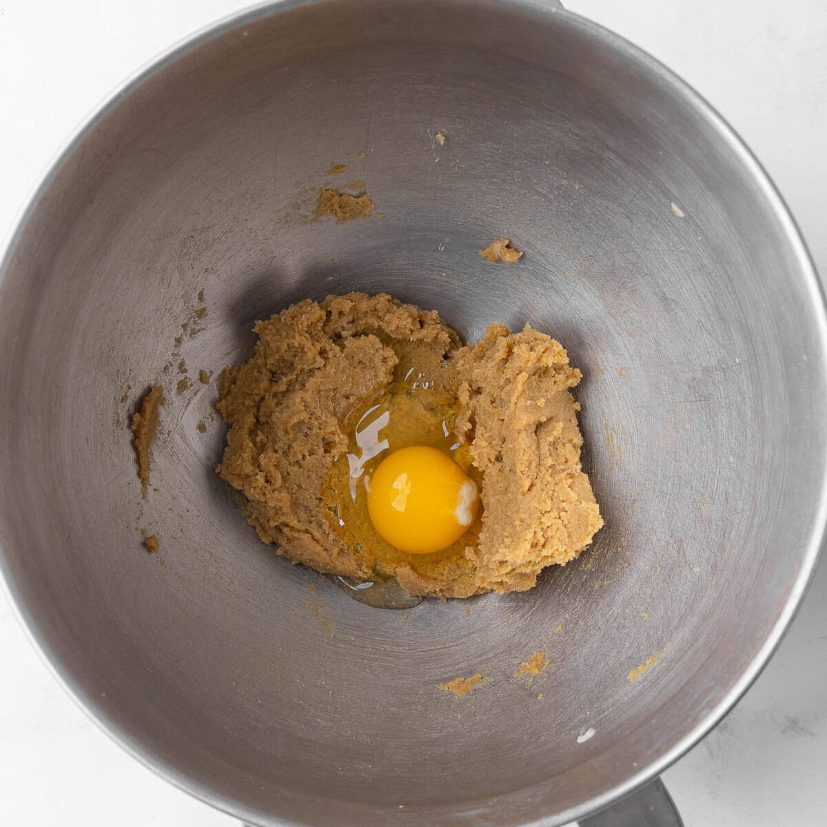 Creamed butter and sugar in a mixer, with egg added on top.