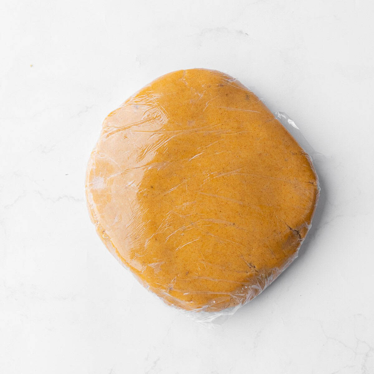 Plastic-wrapped gingerbread cookie dough.