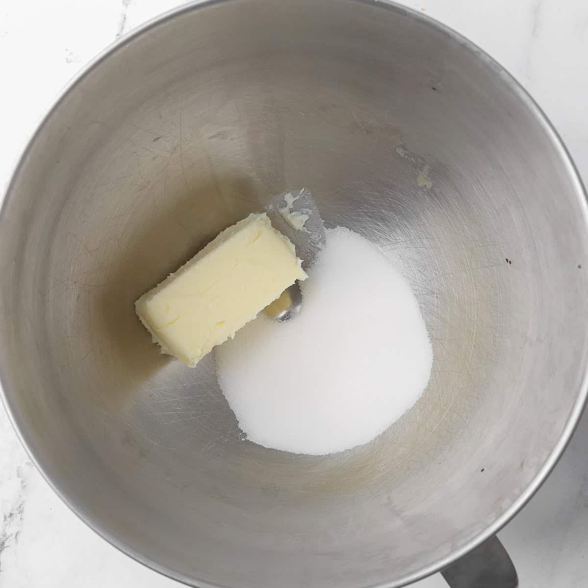 Butter and sugar in the bowl of a stand mixer before creaming.