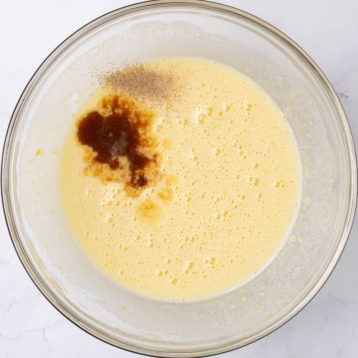 After whisking until pale yellow with cardamom and vanilla added.