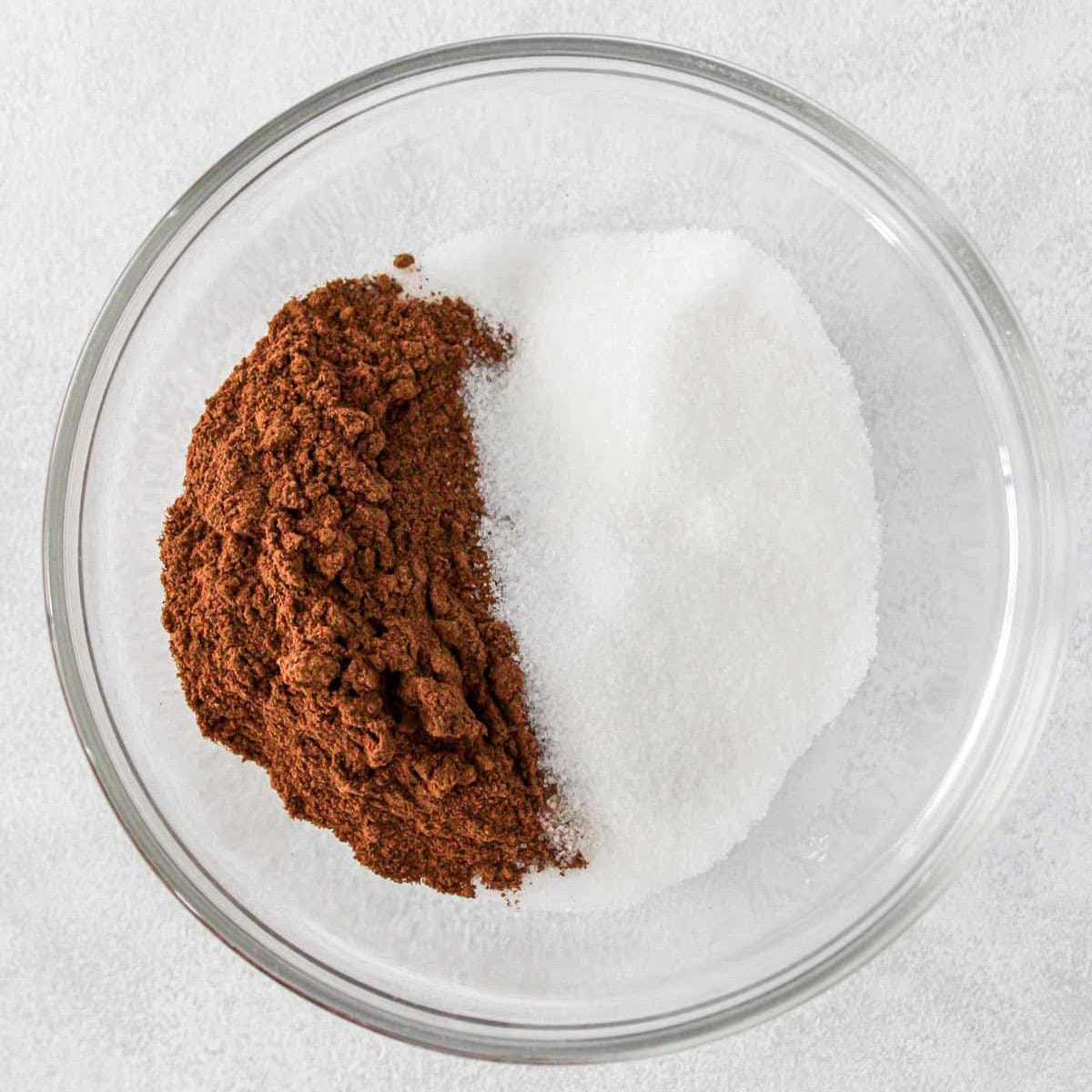 Cinnamon and sugar in a bowl before combining.
