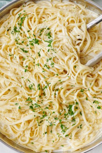 Square image of a pan of cottage cheese alfredo pasta.