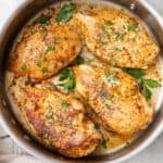 Square image of pan seared chicken in pan.