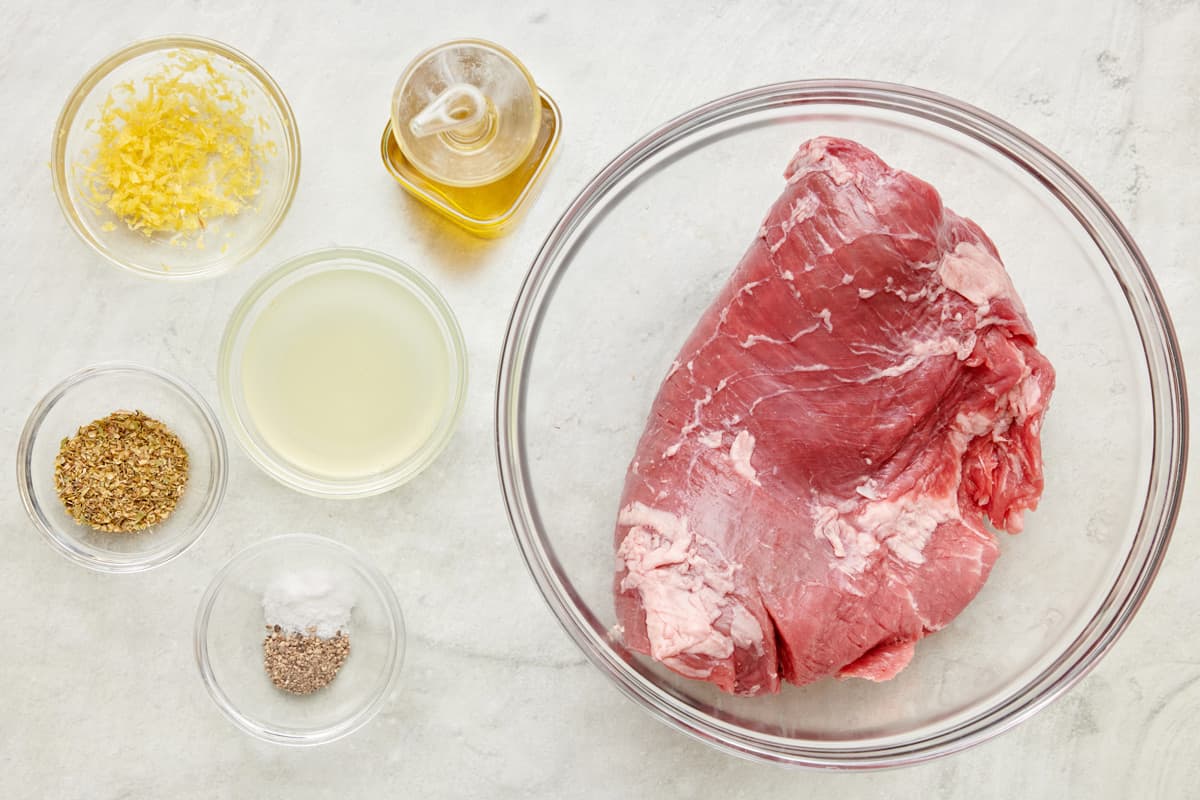 Ingredient for lemon Italian marinade: lemon zest, lemon juice, Italian seasoning, salt and pepper, and steak.