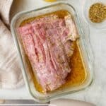 Square image of flank steak in marinade.