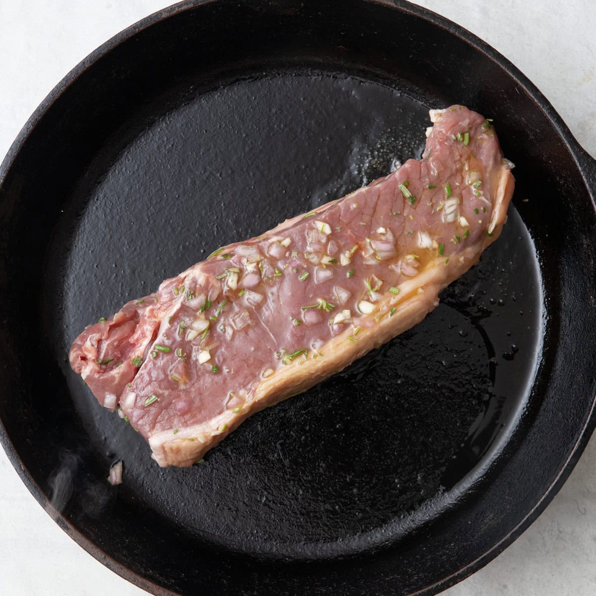 Steak added to the pan.