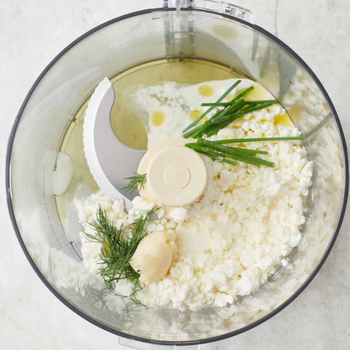 Ingredients to make whipped cottage cheese in a blender before blending.