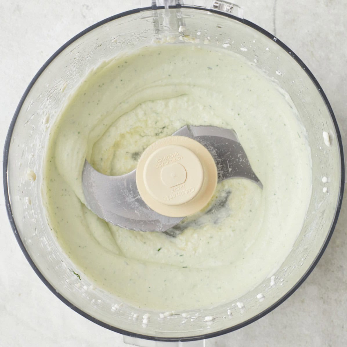 Ingredients to make whipped cottage cheese in a blender after blending.