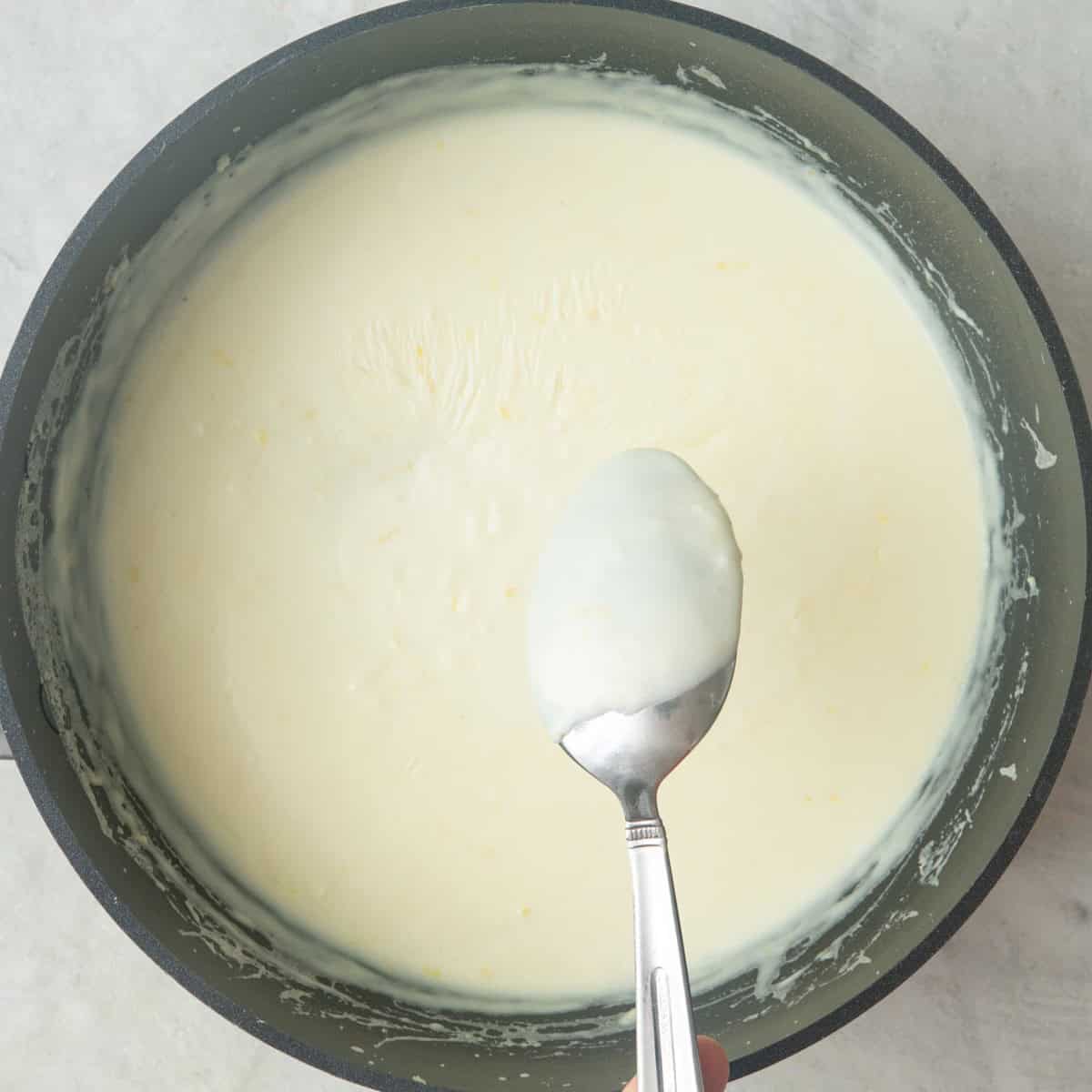 After whisking to show a thickened sauce by dipping a spoon inside and showing it coated with gravy.