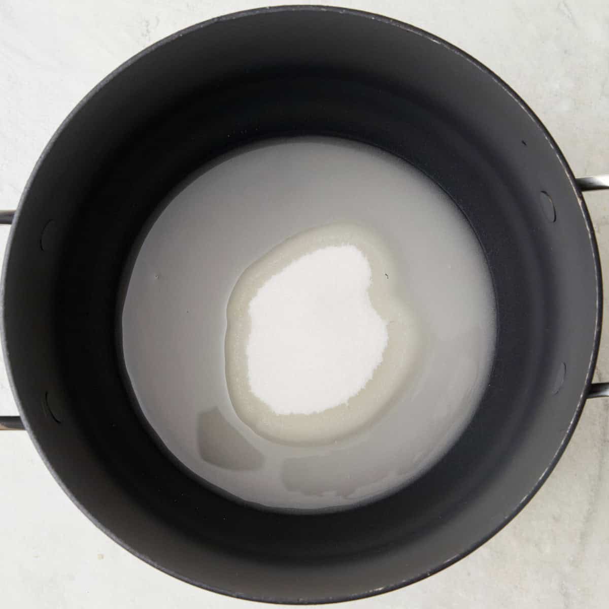Sugar and water in a pot.
