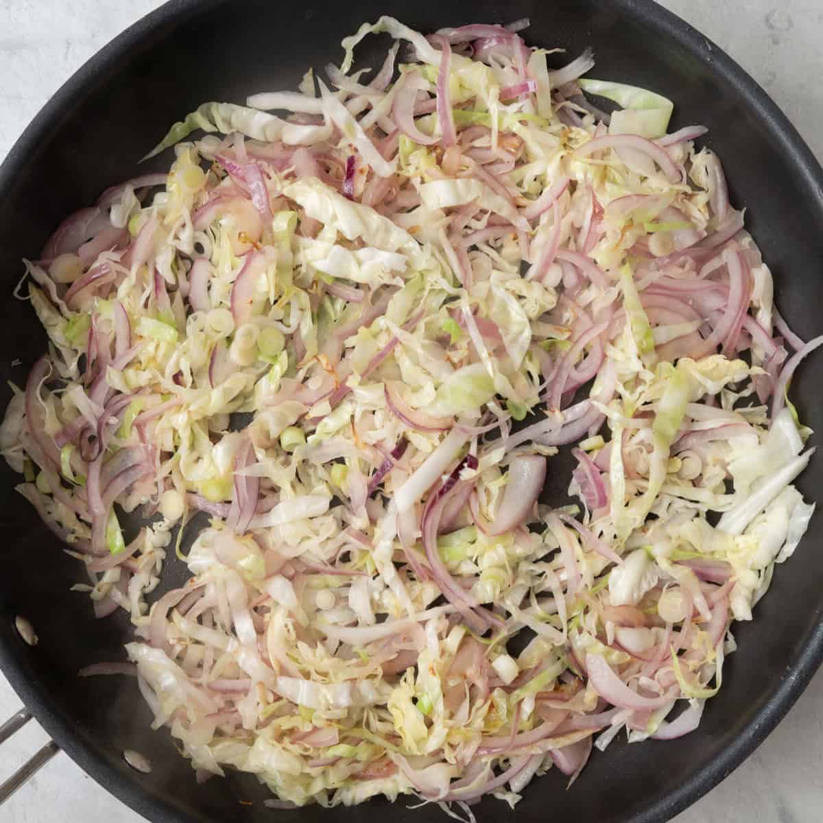 Tofu removed. Onion, scallions, and shredded cabbage after cooked.