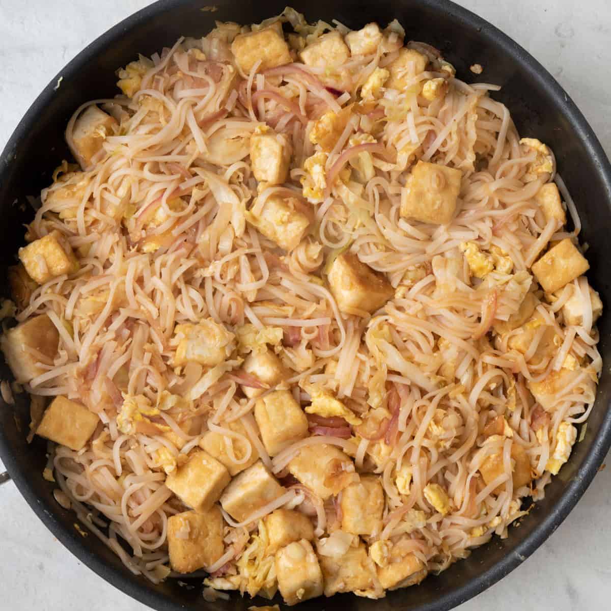 Sauce added and tossed together with eggs and veggie noodle mixture to show final dish.