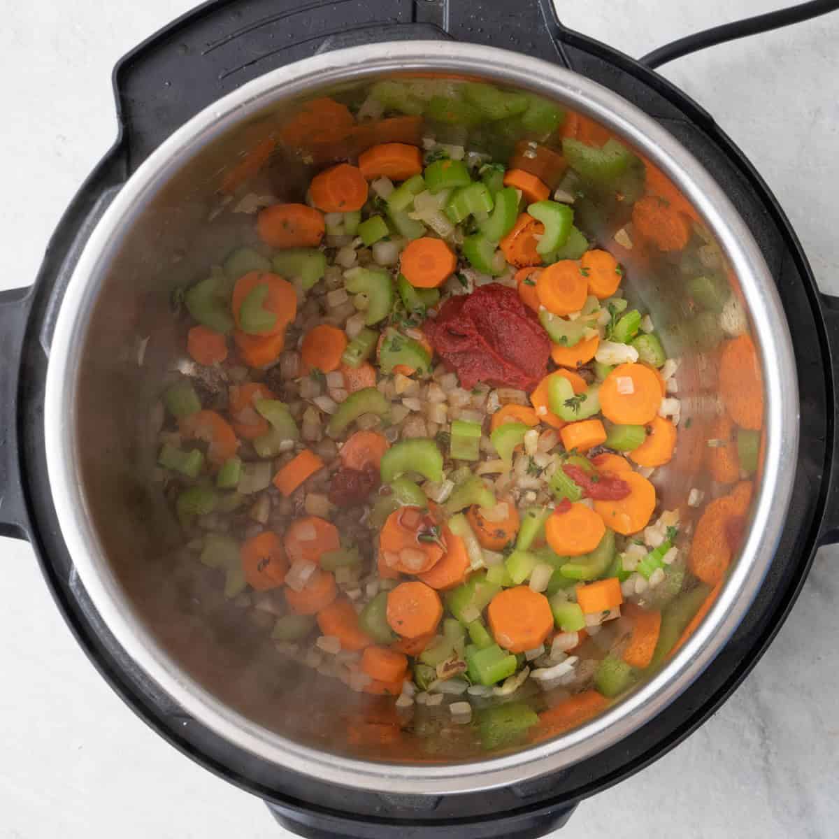After veggies have softened with thyme, tomato paste, and Worcestershire added.